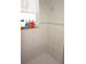 Bathroom shower with tile walls and a window at 25472 Tevesine Ct, Punta Gorda, FL 33983