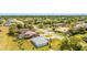An aerial view of a house surrounded by mature trees and lush landscaping, with a defined property line at 25730 Deep Creek Blvd, Punta Gorda, FL 33983