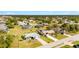 An aerial view of a single-story home with a gray roof and well-maintained landscaping, outlined in yellow at 25730 Deep Creek Blvd, Punta Gorda, FL 33983