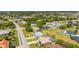 An aerial view of a home with a well-manicured lawn and surrounding neighborhood, outlined in yellow at 25730 Deep Creek Blvd, Punta Gorda, FL 33983