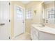Bright bathroom featuring a single vanity and a glass block window for added light at 25730 Deep Creek Blvd, Punta Gorda, FL 33983