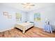 Cozy bedroom featuring hardwood floors, two windows, ceiling fan, and light blue colored walls at 25730 Deep Creek Blvd, Punta Gorda, FL 33983