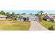 Charming single-story home with a well-manicured lawn, landscaped flowerbeds, and a two-car garage at 25730 Deep Creek Blvd, Punta Gorda, FL 33983