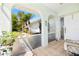 Cozy front porch featuring tiled floor, plants, and an arched entrance that provides curb appeal at 25730 Deep Creek Blvd, Punta Gorda, FL 33983