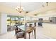 Eat-in kitchen featuring modern appliances, white cabinets, and sliding door access to patio at 25730 Deep Creek Blvd, Punta Gorda, FL 33983