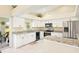 Bright kitchen featuring stainless steel appliances, granite countertops, and backyard access at 25730 Deep Creek Blvd, Punta Gorda, FL 33983