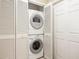 Convenient, space-saving stacked washer and dryer unit, enclosed behind closet doors, ready for laundry day at 25730 Deep Creek Blvd, Punta Gorda, FL 33983
