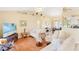 Spacious living room with wood floors, neutral walls, comfortable seating, and ample natural light at 25730 Deep Creek Blvd, Punta Gorda, FL 33983