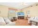 Bright living room featuring wood floors, comfortable seating, and a ceiling fan at 25730 Deep Creek Blvd, Punta Gorda, FL 33983
