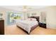 Cozy bedroom with a slider to the porch offering natural light and backyard views at 25730 Deep Creek Blvd, Punta Gorda, FL 33983