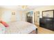 Bright bedroom featuring a decorative ceiling fan, two closets, and an ensuite bathroom at 25730 Deep Creek Blvd, Punta Gorda, FL 33983