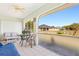 Relaxing enclosed patio with tiled floors, ceiling fan, and views of the backyard and neighboring homes at 25730 Deep Creek Blvd, Punta Gorda, FL 33983