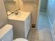 A bathroom featuring a toilet, vanity with sink, and mirror at 30147 Holly Rd, Punta Gorda, FL 33982