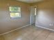 A bedroom featuring a window and tile flooring at 30147 Holly Rd, Punta Gorda, FL 33982