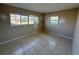 A bedroom featuring tile flooring and a large window, providing a bright and airy space at 30147 Holly Rd, Punta Gorda, FL 33982