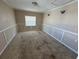 Bedroom with paneled walls and a window at 30147 Holly Rd, Punta Gorda, FL 33982