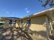 Rear view of home with yellow stucco and several small windows, fence on the right at 30147 Holly Rd, Punta Gorda, FL 33982
