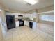 Well-lit kitchen featuring white cabinets and black appliances at 30147 Holly Rd, Punta Gorda, FL 33982