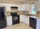 Updated kitchen with black appliances and bright cabinets at 30147 Holly Rd, Punta Gorda, FL 33982
