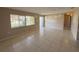 A living room featuring tile flooring, a large window, and an entrance door, providing a bright and airy space at 30147 Holly Rd, Punta Gorda, FL 33982