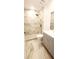 Modern bathroom showcasing marbled tile walls, a walk-in shower, and a gray vanity at 3372 Elkcam Blvd, Port Charlotte, FL 33952