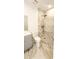 Bathroom with marble floors, tiled shower with rainfall showerhead, modern vanity, and white toilet at 3372 Elkcam Blvd, Port Charlotte, FL 33952