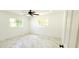 Bright bedroom with marble floors, recessed lighting and two large windows at 3372 Elkcam Blvd, Port Charlotte, FL 33952