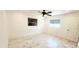 Comfortable bedroom featuring marble-look tile flooring, two windows, and white walls at 3372 Elkcam Blvd, Port Charlotte, FL 33952