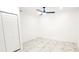 Bedroom with ceiling fan, marble floors, and closet with sliding doors at 3372 Elkcam Blvd, Port Charlotte, FL 33952