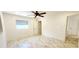 Bright bedroom with marble-look tile floors, white walls, a ceiling fan, and natural light at 3372 Elkcam Blvd, Port Charlotte, FL 33952
