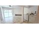 An interior laundry room features marble floors, a modern washer and dryer, and a built-in bench at 3372 Elkcam Blvd, Port Charlotte, FL 33952
