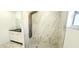 Contemporary bathroom featuring a marble tiled shower with a rainfall showerhead and a sleek vanity at 3372 Elkcam Blvd, Port Charlotte, FL 33952