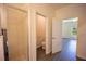 This bathroom features tiled shower, toilet and door leading to a bedroom with a ceiling fan at 359 Paramaribo St, Punta Gorda, FL 33983