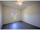 This light and airy bedroom features a ceiling fan, light colored walls, and a large window at 359 Paramaribo St, Punta Gorda, FL 33983