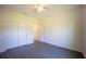 This bedroom boasts a ceiling fan, closet and neutral walls and floors creating a calming retreat at 359 Paramaribo St, Punta Gorda, FL 33983