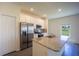 Modern kitchen with granite countertops, stainless steel appliances, and a pantry at 359 Paramaribo St, Punta Gorda, FL 33983