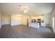 Spacious living room featuring a modern kitchen, ceiling fan, and hardwood floors at 359 Paramaribo St, Punta Gorda, FL 33983