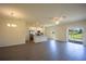 Open-concept living room with kitchen featuring granite countertops and stainless steel appliances at 359 Paramaribo St, Punta Gorda, FL 33983