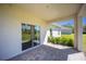 Covered patio with sliding glass doors and views of the landscaped backyard at 359 Paramaribo St, Punta Gorda, FL 33983