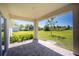 Covered patio with brick flooring and views of the landscaped backyard at 359 Paramaribo St, Punta Gorda, FL 33983