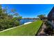 Lush backyard with a concrete seawall, green grass, and peaceful canal views at 3606 Whippoorwill Blvd, Punta Gorda, FL 33950