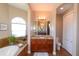 Bathroom with a soaking tub, vanity, and tile flooring at 3606 Whippoorwill Blvd, Punta Gorda, FL 33950