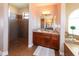 This bathroom boasts a granite-topped vanity, tiled shower, and steps leading up to a luxurious tub at 3606 Whippoorwill Blvd, Punta Gorda, FL 33950