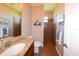 Bathroom featuring a granite vanity, toilet, and tiled shower at 3606 Whippoorwill Blvd, Punta Gorda, FL 33950