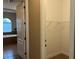En suite bathroom featuring a soaking tub and a walk-in closet with built-in shelving at 3606 Whippoorwill Blvd, Punta Gorda, FL 33950
