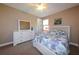 Bright bedroom with a floral patterned bed, white dresser, and overhead ceiling fan at 3606 Whippoorwill Blvd, Punta Gorda, FL 33950
