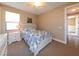 Bright bedroom with a floral patterned bed, white dresser, and overhead ceiling fan at 3606 Whippoorwill Blvd, Punta Gorda, FL 33950