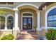 Charming front entrance with brick steps, decorative columns, and a double-door entry at 3606 Whippoorwill Blvd, Punta Gorda, FL 33950