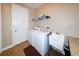 A utility room features a white washer and dryer, a sink and storage area, offering convenience and functionality at 3606 Whippoorwill Blvd, Punta Gorda, FL 33950