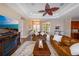 Comfortable living room featuring leather furniture, a fireplace, and views into the foyer at 3606 Whippoorwill Blvd, Punta Gorda, FL 33950